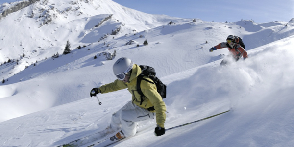 Two people skiing down a mountain